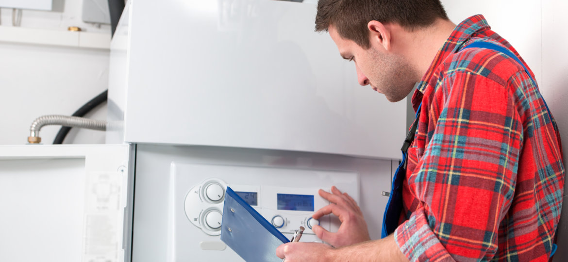 Technician servicing heating boiler